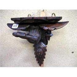 A Black Forest carved eagle wall bracket....