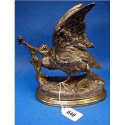 A Spelter figure of a bird, signed Comolbra....