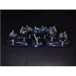 Group of seven, globes with pen holders, all