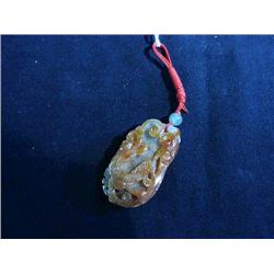 Chinese, carved rust-color jadeite pendant wi