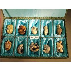 Box of ten, carved and stained ivory netsuke,