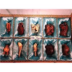 Box of ten, carved wood and ivory netsuke, mo
