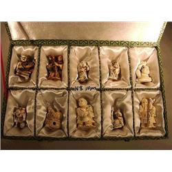 Box of ten, carved and lightly stained ivory