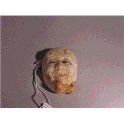 Well-carved and detailed, ivory mask netsuke