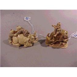 Two well-carved and highly detailed ivory net