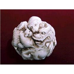 Unusual, carved ivory "ball"-form okimono dep