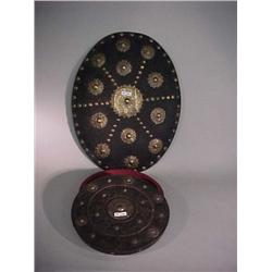Wood shield with repousse