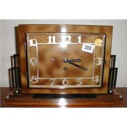 An Art Deco mantel clock with chrome decor...
