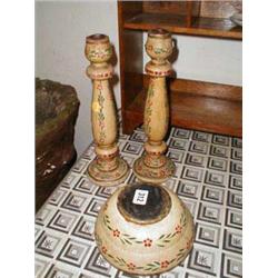Two wooden candlesticks together with a wo...