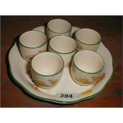 A c1910/15 set of six egg-cups on stand wi...