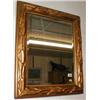 Image 1 : A bevel-edged mirror in gilt stucco frame...