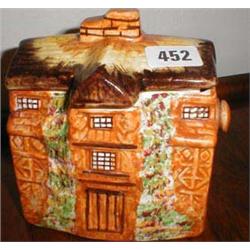 A c1930's Arthur Wood biscuit barrel in th...