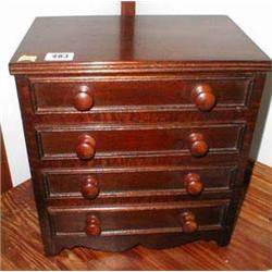 A miniature mahogany chest of four drawers...