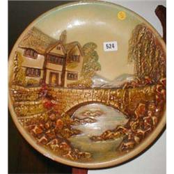 A plaster wall plaque with relief scene...