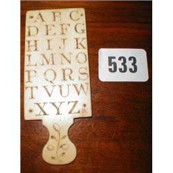 A C19th ivory child's alphabet paddle with...