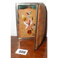 A leather cigar case with embroidered pock...