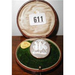A cameo broach of three dancing girls in a...