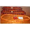 Two red amber stringed necklaces and one o...