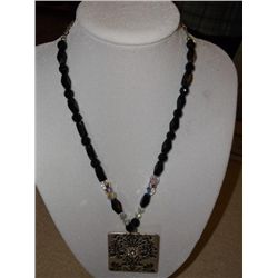 woman's black stone Neckless w/ white metal rhinestone medallion