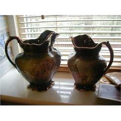 TWO GRADUATED STAFFORDSHIRE POTTERY JUGS...