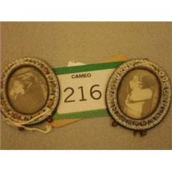 Two antique brass oval frames with porcelain...