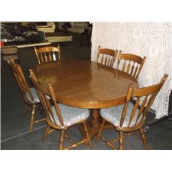 Maple Dining Room table with 6 chairs the table has 2 leaves and all the chairs have seat cushions t