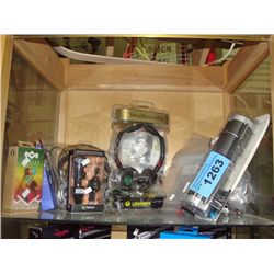 Shelf lot of assorted headphones, ear buds and other electronic accessories