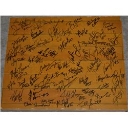 A piece of the original Williams Arena floor, autographed by many former Gopher Players and Coaches