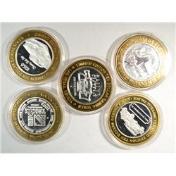 5 DIFF. SILVER CASINO TOKENS, TRAINS AND AUTOS.