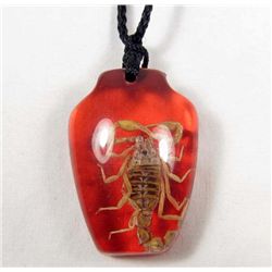 6945 - RED COLORED RESIN PENDANT WITH REAL SCORPION