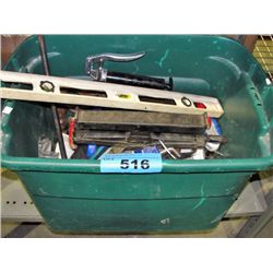 Green plastic storage bin filled with assorted