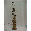 Image 2 : Gilt metal figural lamp of woman holding torch, one foot on books