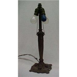 Metal lamp with swirl and floral raised decoration