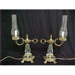 A pair of brass and cut crystal hurricane lamps