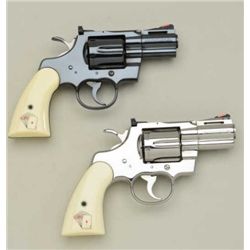 Factory display wood and glass “Snake Eyes”  display case with pair of Colt short barreled  Python D