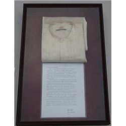 Beautifully framed in wood and glass  “shadowbox”, a Monarch Trade-mark linen white  shirt, inked be