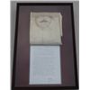 Beautifully framed in wood and glass  “shadowbox”, a Monarch Trade-mark linen white  shirt, inked be