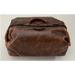 Folding leather valise approx. 21” long, 12”  wide and 9” in height with brass clasps,  leather hand