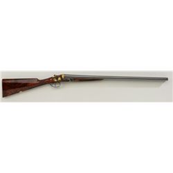 John Wilkes full side lock double barrel  shotgun with ornate multi colored gold inlays  and extra h