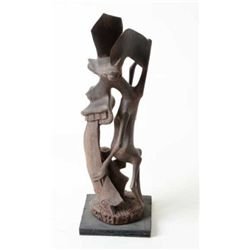 Arfican tribal carving with very stylized  figures measures approx. 20” in height  mounted on base w