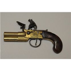 Three barrel tap-action Flintlock pistol with  brass body signed “Sykes, Oxford”. The  pistol measur