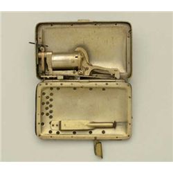 Frankenau’s patent purse pistol containing a  5.5mm DA revolver which can be fired while  holding pu