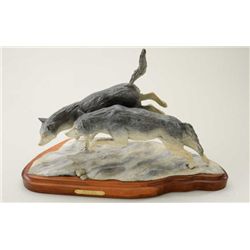 Original bronze portraying wolves entitled  “Break Away” by Renee Headings.  The bronze  measures 18