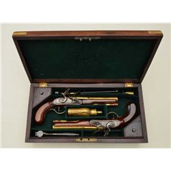 Pair of English Flintlock pistols in their  original case by Gill & Parker showing brass  barrels an