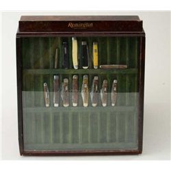 Older Remington wood and glass folding knife  display for a store counter containing 14  assorted ex
