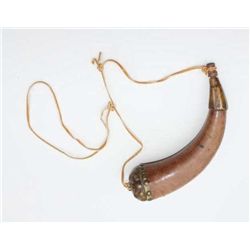 Old powder horn wrapped in leather with brass  tack decoration on bottom wood plug and base  of horn