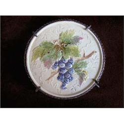 Majolica Round Hot Plate Tile in a looped wire framed edge w/looped feed. Grape pattern w/greens, ro