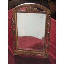 Art Nouveaux Pierced and Floral Iron Frame with worn Brass Finish Dresser Mirror. Has beveled glass.