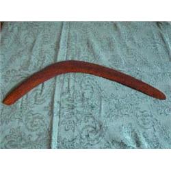 Relief carved wooden Boomerang. Relief depicts 2 horses with rider falling off lead horse. Chain and