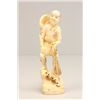 Image 1 : Carved bone figure "Man Holding Net"